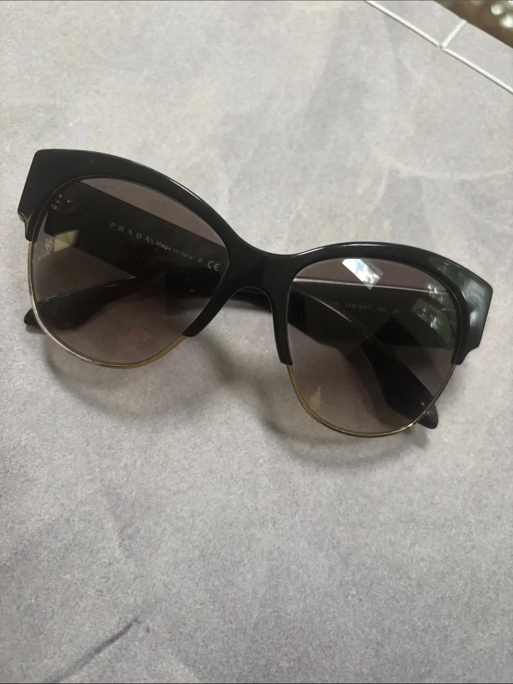 Prada Black Cat-Eye Sunglasses with Gold Trim